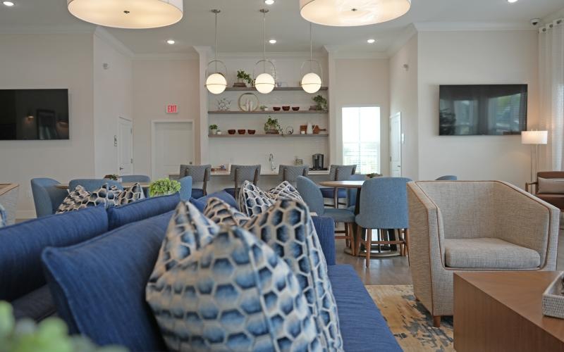 a room with blue chairs and a television