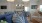 a room with blue chairs and a television